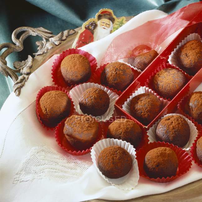 Vue rapprochée des truffes au rhum avec boîte et ruban sur tissu — Photo de stock