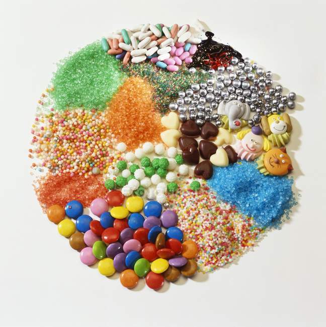 Closeup view of assorted cake decorations on white surface — Stock Photo