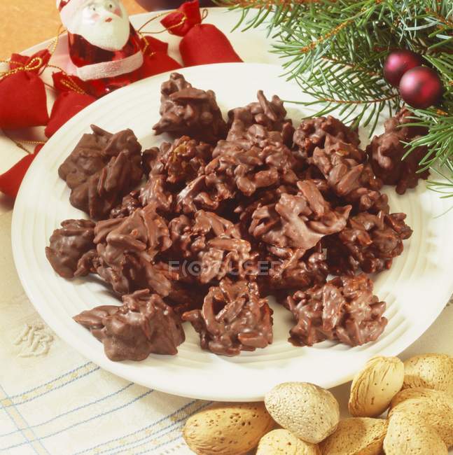 Closeup view of chocolate almond clusters on a plate — Stock Photo