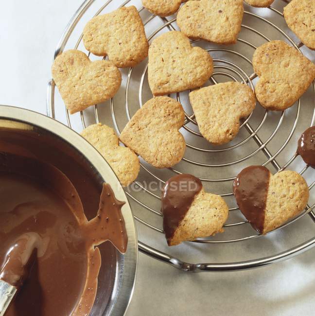 Closeup top view of nut hearts and chocolate dip — Stock Photo