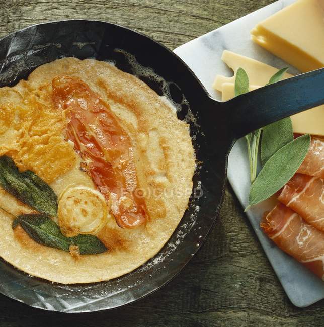 Omelette with bacon in pan — Stock Photo