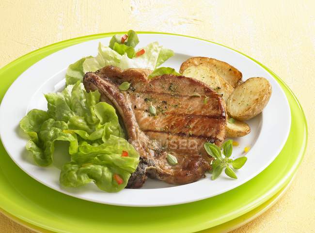 Grilled pork chop with fried potatoes — Stock Photo