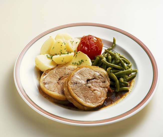 Saddle of lamb with potatoes and beans — Stock Photo