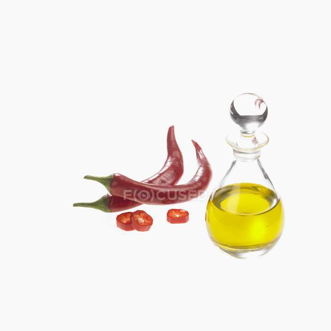Chilli peppers and oil — Stock Photo
