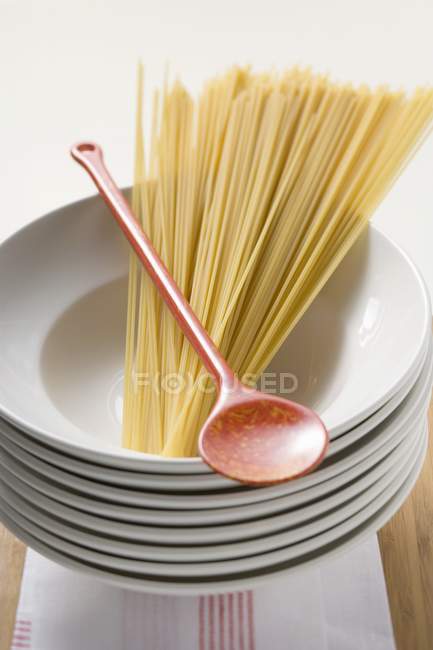 Spaghetti with cooking spoon — Stock Photo