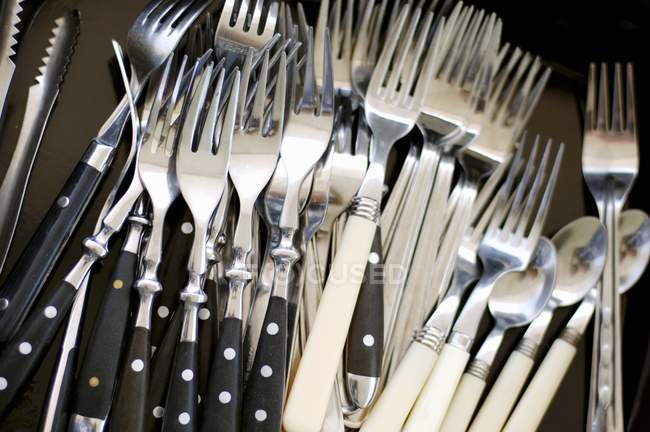 Closeup view of different forks and teaspoons in heap — Stock Photo