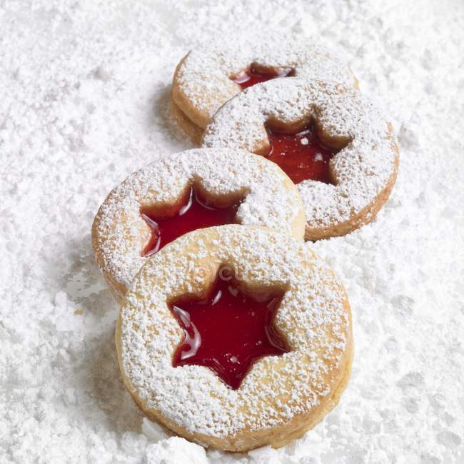 Linzer biscuits on icing sugar — Stock Photo