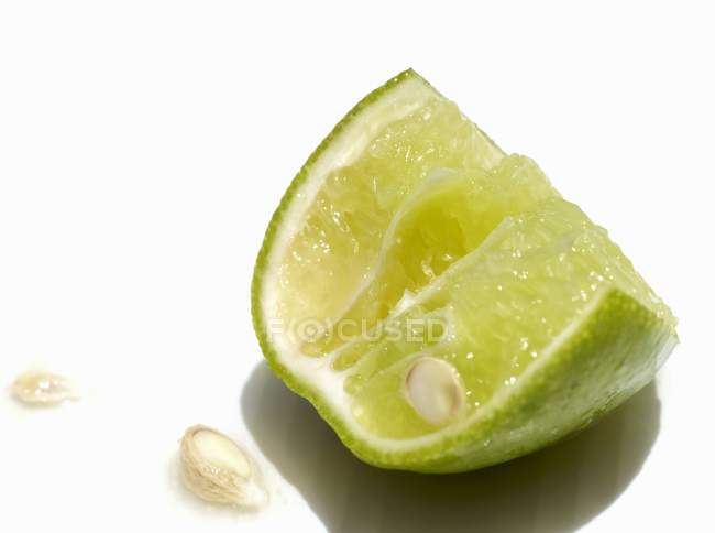 Piece of lime with pips — Stock Photo