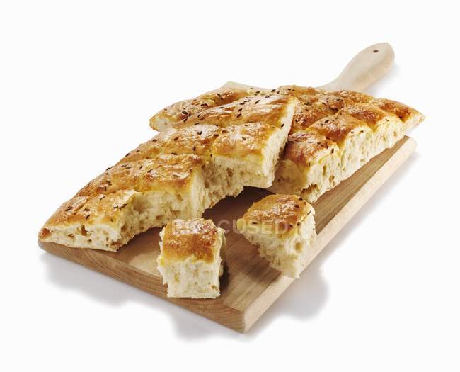 Partly sliced Slovenian flatbread with caraway — Stock Photo