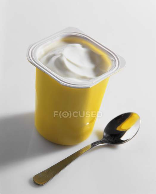 Yoghurt in plastic pot — Stock Photo