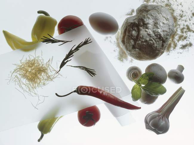 Pizza ingredients on white surface — Stock Photo