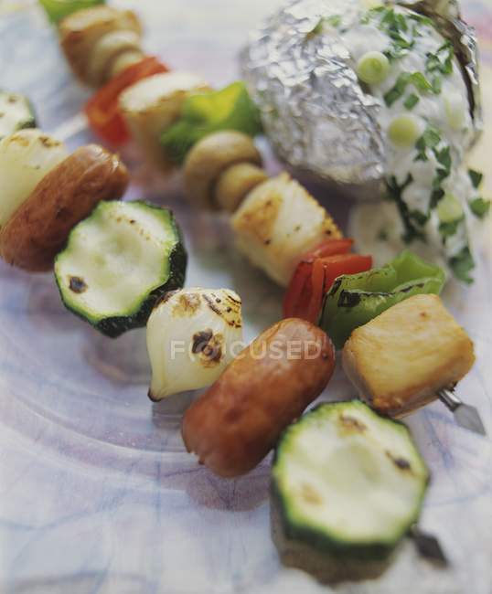 Two kebabs: sausage, chicken and vegetable on marble plate — Stock Photo
