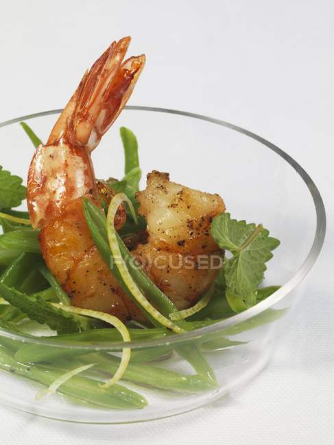 Bean salad with prawn in glass bowl on white background — Stock Photo