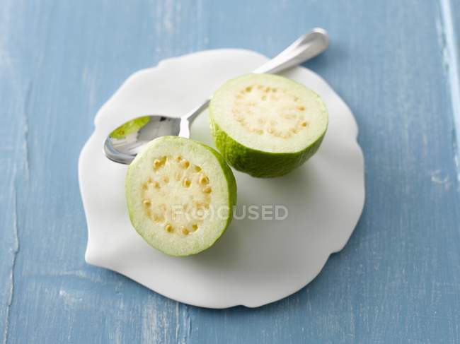 Halved guava with spoon — Stock Photo