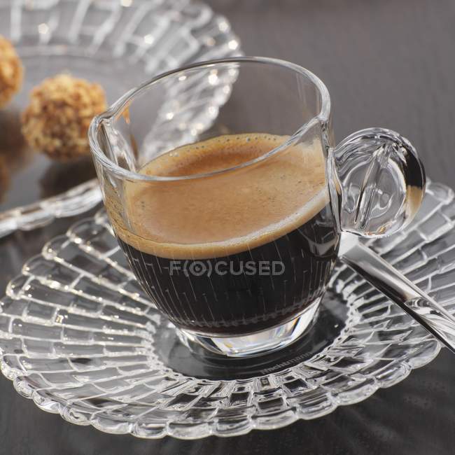Espresso in glass cup and saucer — Stock Photo