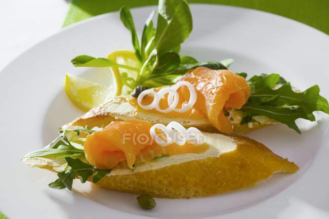 Smoked salmon on baguette slices — Stock Photo