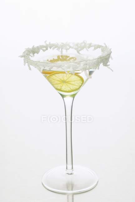 Closeup view of Sambuca anise liqueur with lemon and grated coconut — Stock Photo