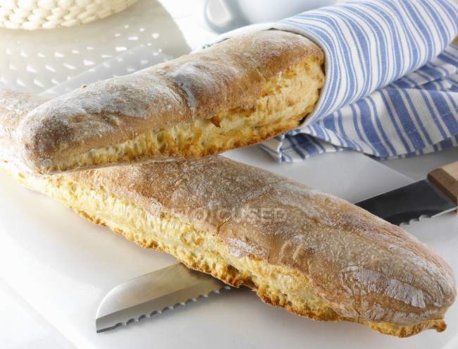 Spelt baguettes with knife — Stock Photo