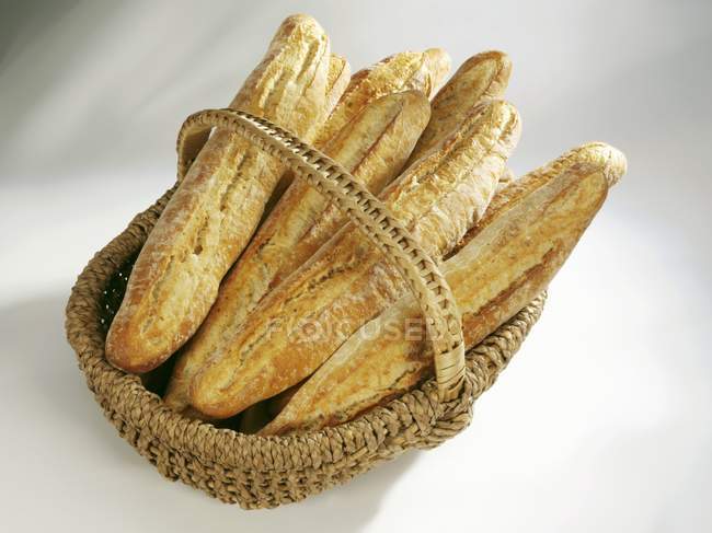 Crusty French loaves in basket — Stock Photo