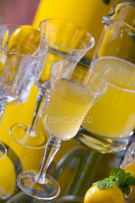 Lemonade in jug and glass — Stock Photo