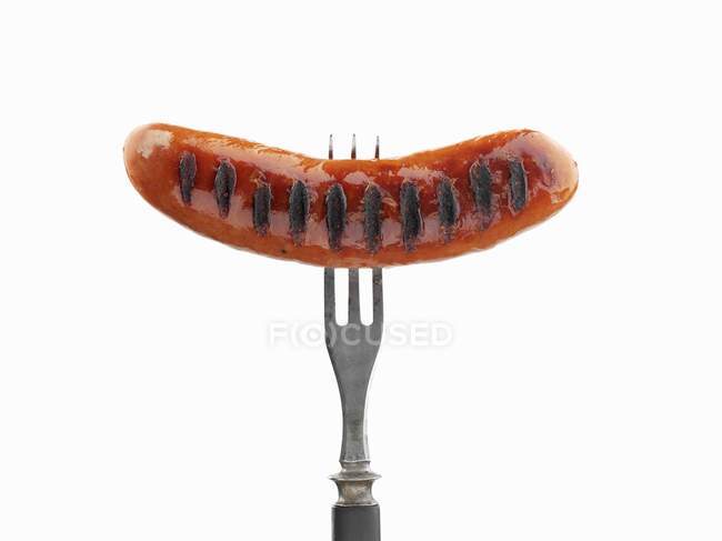 Grilled sausage on fork — Stock Photo