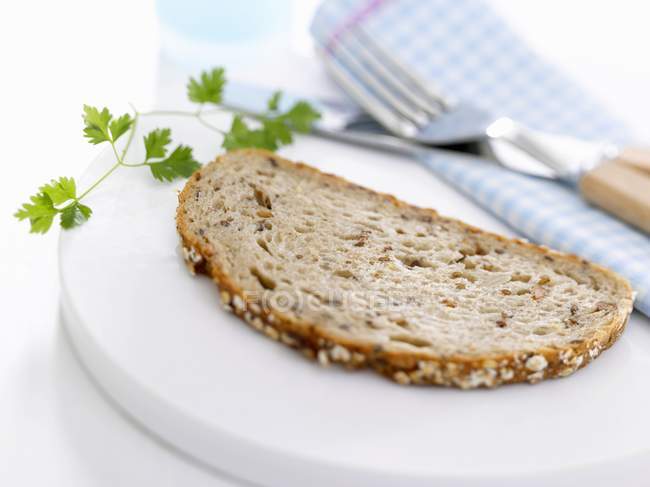 Slice of granary bread with chervil — Stock Photo
