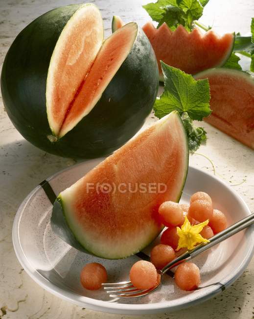 Slices and balls of watermelon — Stock Photo