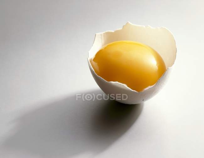 Egg yolk in eggshell — Stock Photo
