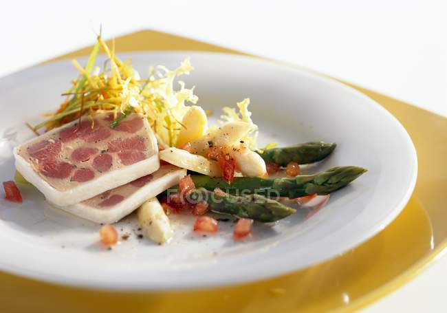 Marinated asparagus with duck terrine on white plate — Stock Photo