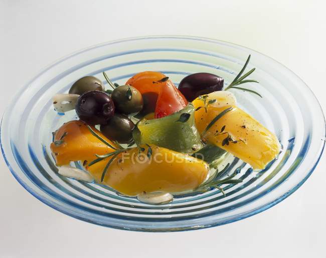 Closeup view of marinated peppers with olives — Stock Photo