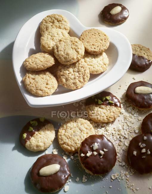 Chocolate-dipped and coated oat biscuits — Stock Photo