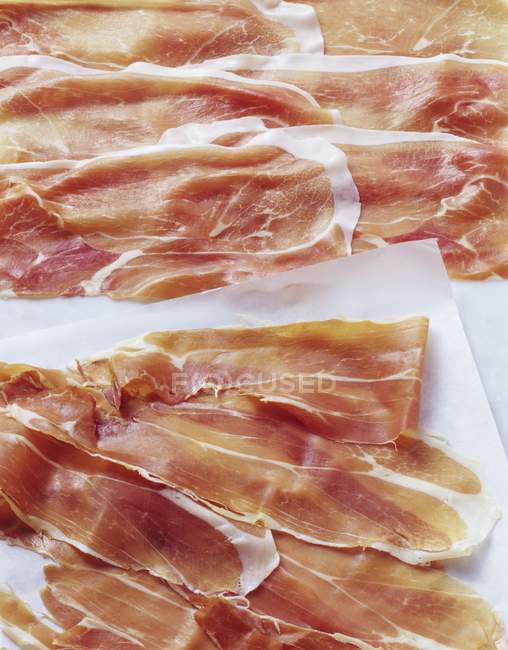 Sliced Parma and San Daniele ham — Stock Photo