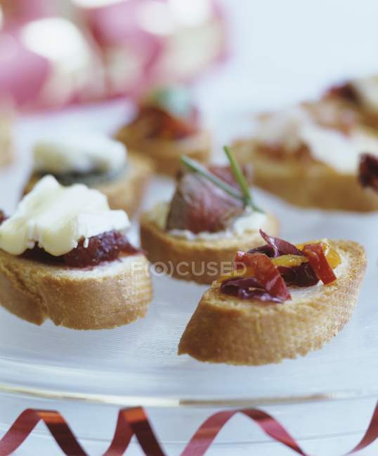 Baguette slices with toppings — Stock Photo