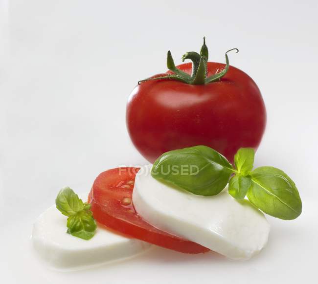 Mozzarella with tomato and basil — Stock Photo