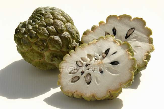 Whole sugar-apple and two halves — Stock Photo