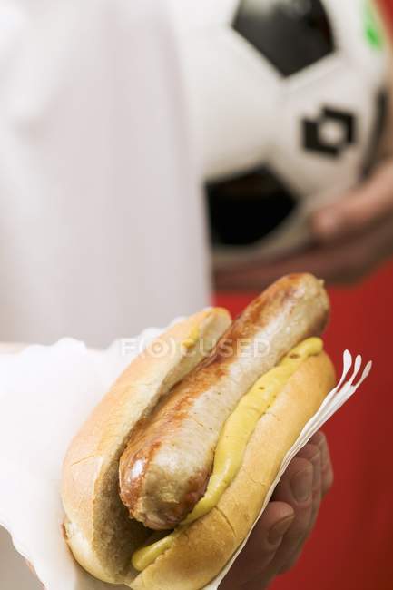 Fußballer hält Hotdog in der Hand — Stockfoto