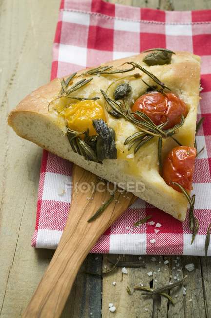 Slice of pizza with cherry tomatoes — Stock Photo