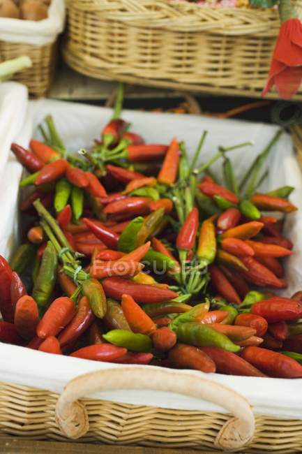Fresh chili peppers in basket — Stock Photo