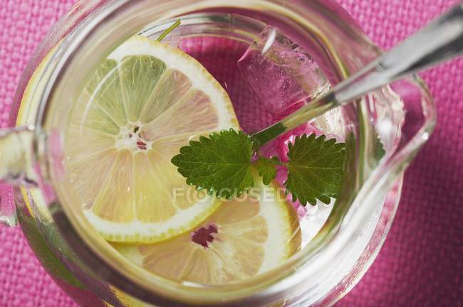 Lemonade with ice cubes and lemon balm — Stock Photo