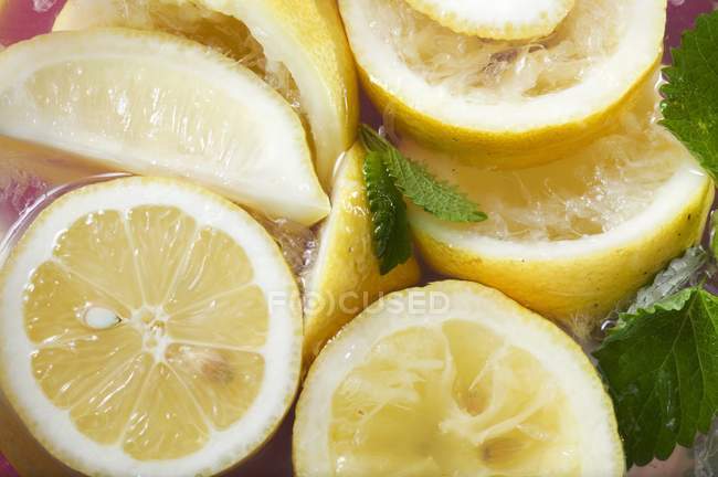 Squeezed lemons in water — Stock Photo