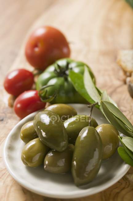 Зеленые оливки на тарелке — стоковое фото