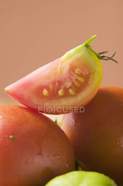 Cuña entera Tomates maduros frescos - foto de stock