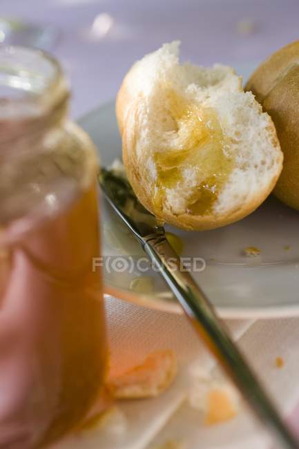 Bread roll with honey — Stock Photo