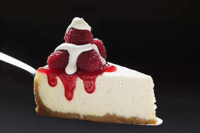 Slice of cheesecake with raspberries — Stock Photo