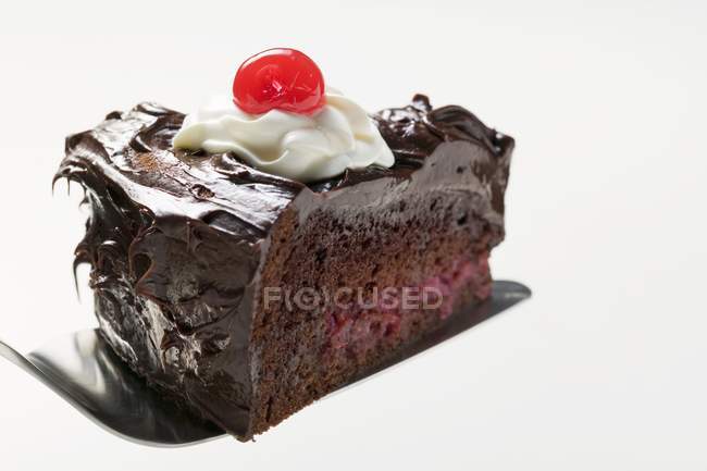 Chocolate cake with cream and cherry — Stock Photo