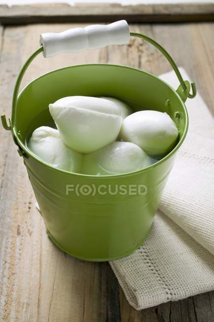 Mozzarella with brine in bucket — Stock Photo