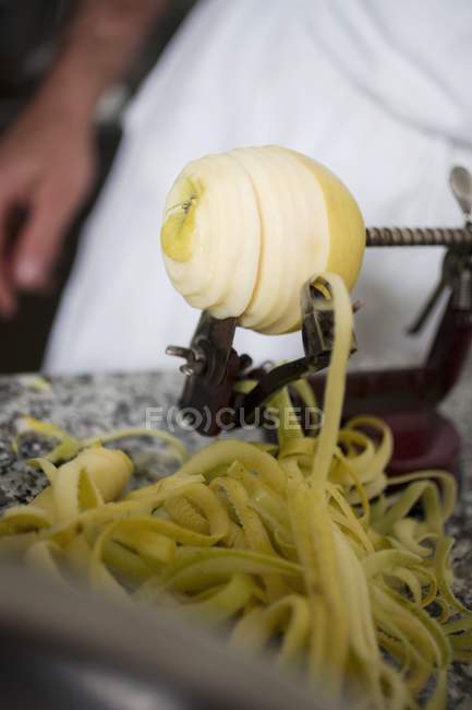 Closeup view of peeling an apple and cutting to a spiral — Stock Photo