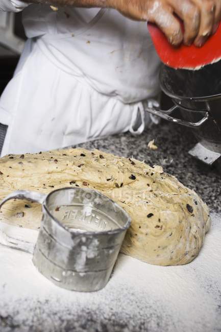 Making olive bread by man over kitchen table — Stock Photo