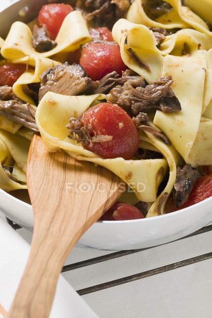 Pappardelle pasta with oxtail and tomatoes — Stock Photo