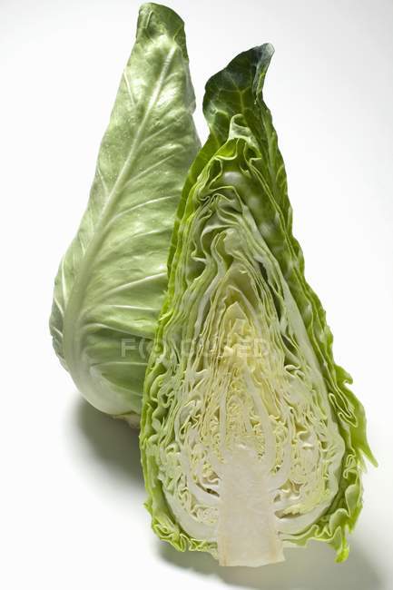 Half and whole pointed cabbages — Stock Photo